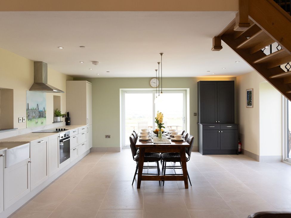A kitchen with dining area at Golygfa Cwrt near Bontgoch and Penrhyncoch