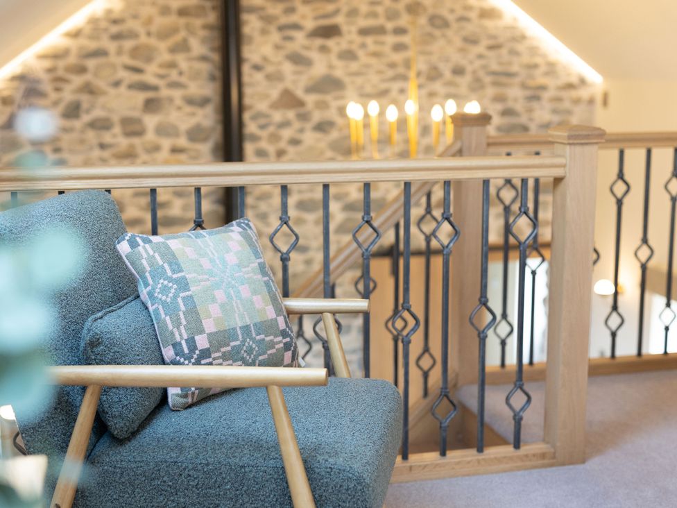 A landing with a chair and a cushion at Golygfa Cwrt near Bontgoch and Penrhyncoch