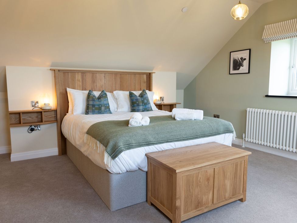 A bedroom with a bed and bedside table at Golygfa Cwrt near Bontgoch and Penrhyncoch