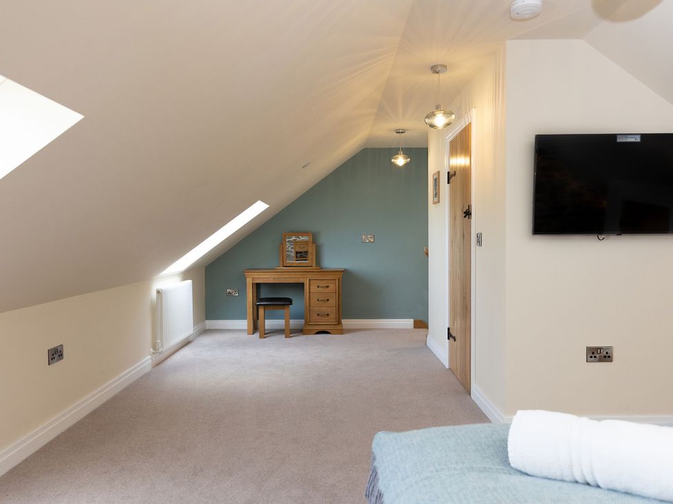 An attic room with a desk and chair at Golygfa Cwrt Near Bontgoch and Penrhyncoch