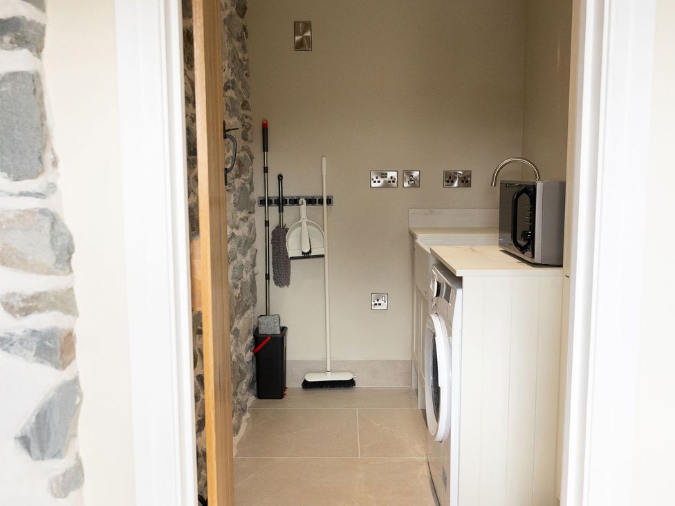 A laundry room featuring a washing machine and dryer at Golygfa Cwrt near Bontgoch and Penrhyncoch