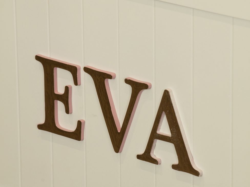 A wall with the letters EVA at Taigh Eva near Lochmaddy