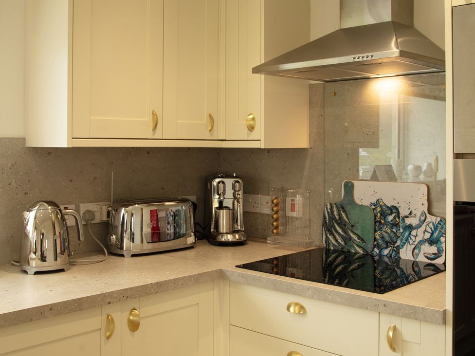 A kitchen with appliances on the countertop at Taigh Eva near Lochmaddy