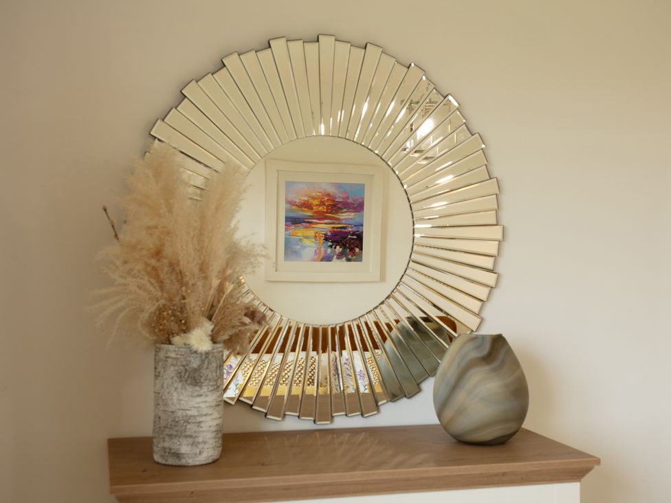 A mirror and vases on a shelf at Taigh Eva near Lochmaddy