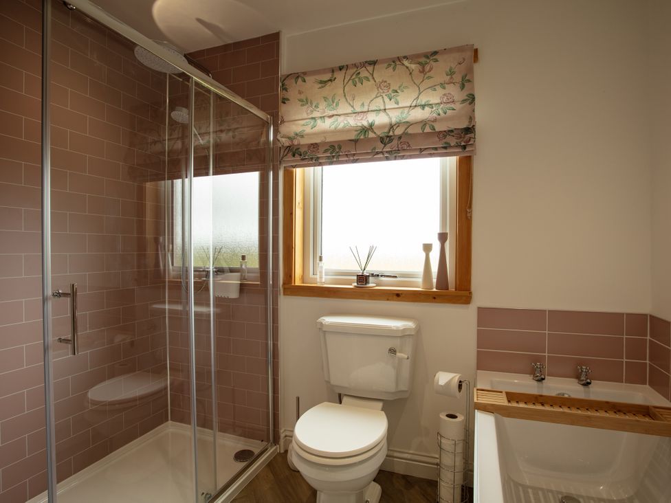 A bathroom with shower, toilet and sink at Taigh Eva near Lochmaddy