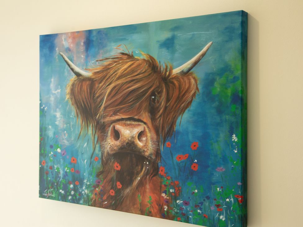 A painting of a highland cow among flowers at Taigh Eva near Lochmaddy