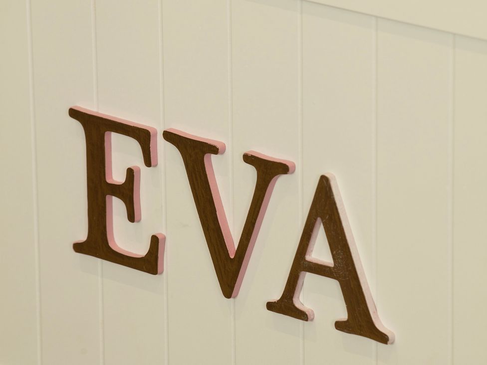 A wooden sign with the name EVA at Taigh Eva near Lochmaddy