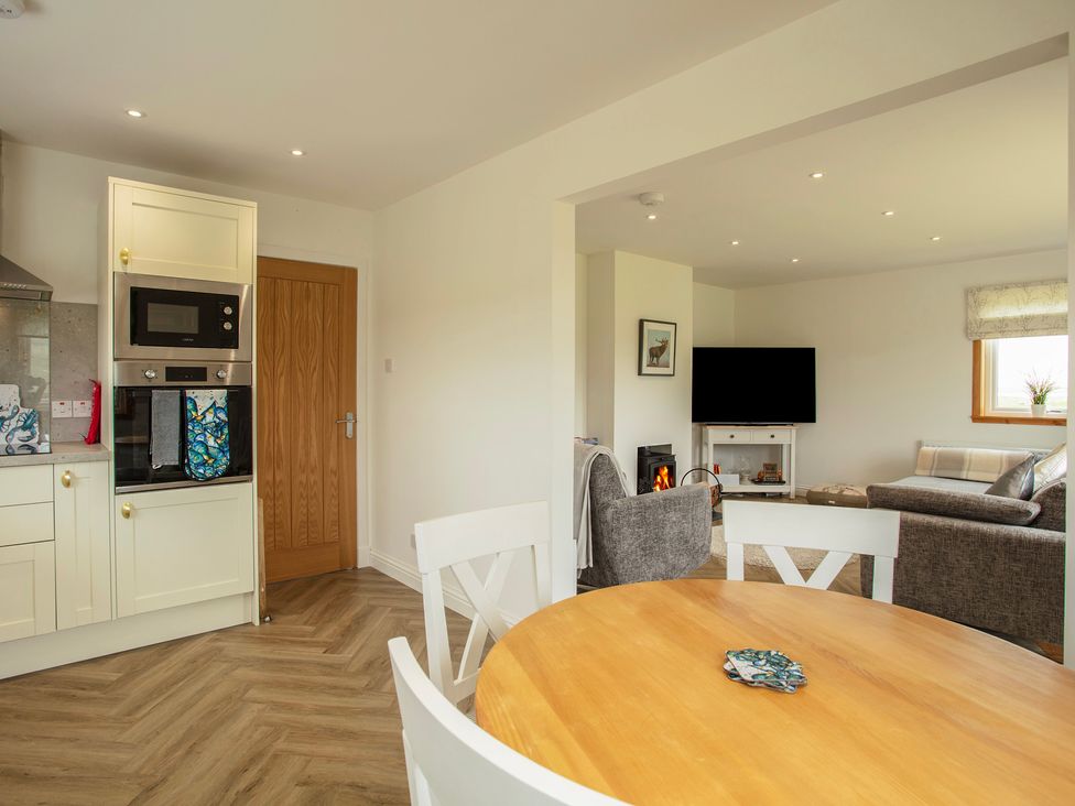 A kitchen with a table and chairs at Taigh Eva near Lochmaddy