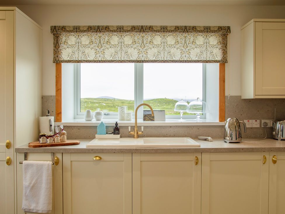 A kitchen with a sink and kettle at Taigh Eva near Lochmaddy