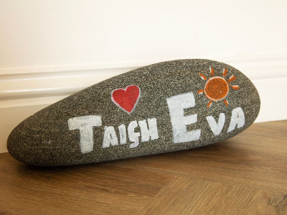 A decorated rock with the name Taigh Eva at Taigh Eva near Lochmaddy