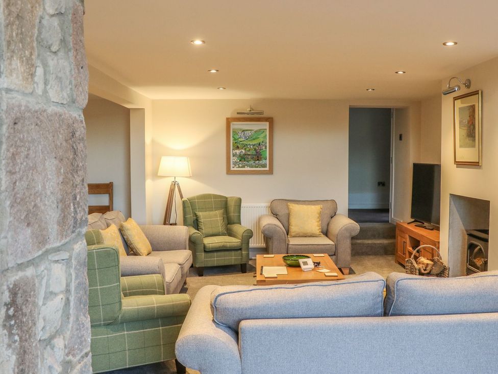 A living room with sofas and a television at Fogga Croft in Skipton