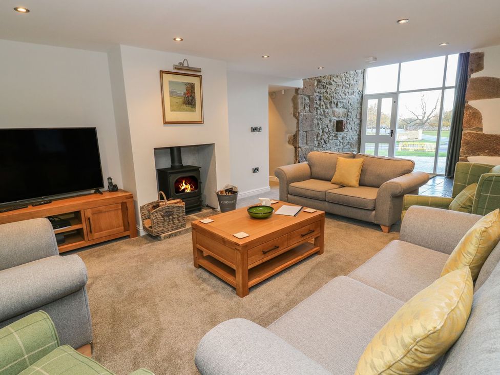 A living room with a television and fireplace at Fogga Croft in Skipton