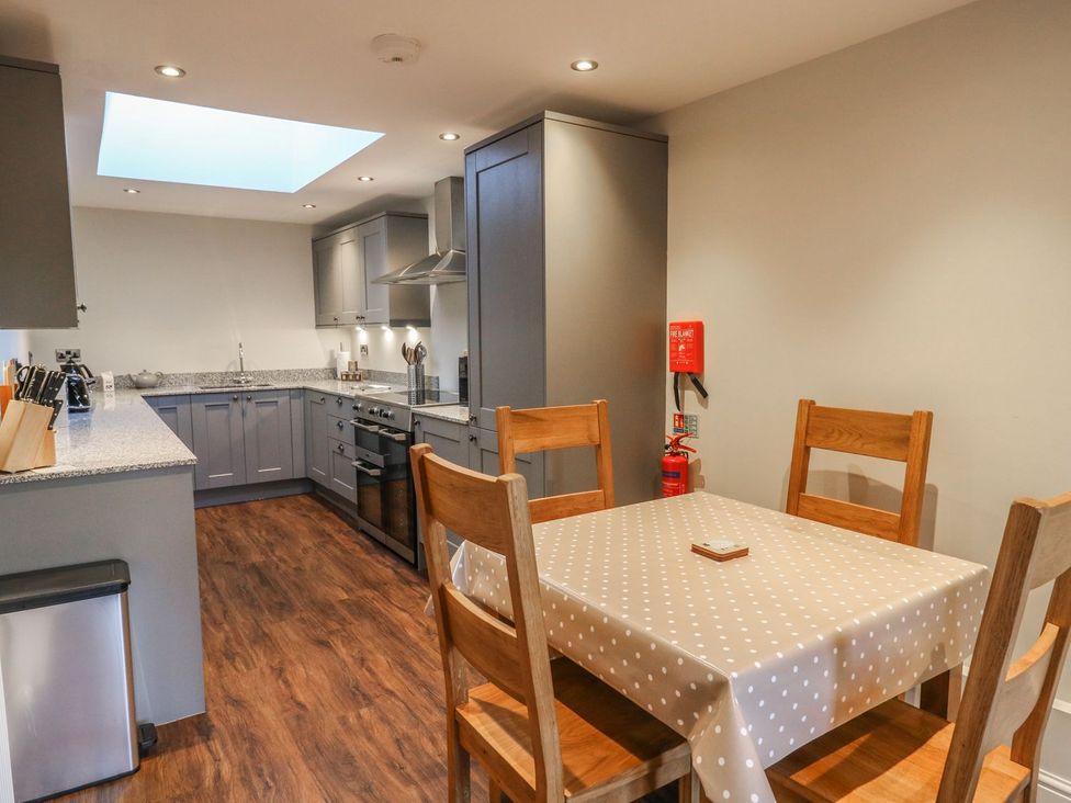 A kitchen with a table and chairs at Fogga Croft in Skipton