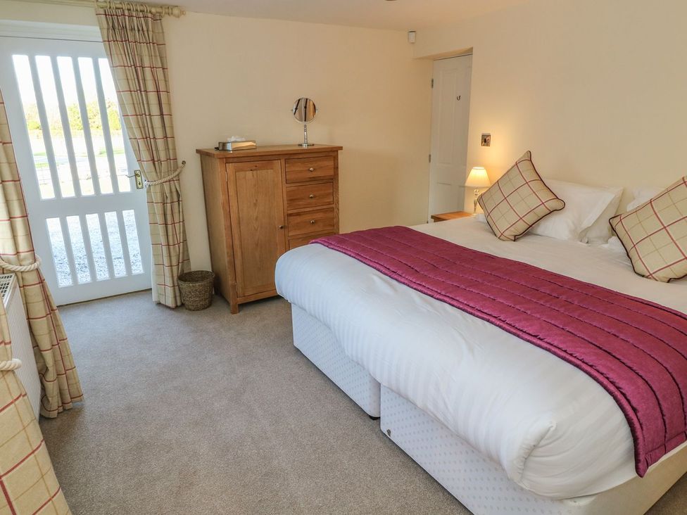 A bedroom with a bed and chest of drawers at Fogga Croft in Skipton