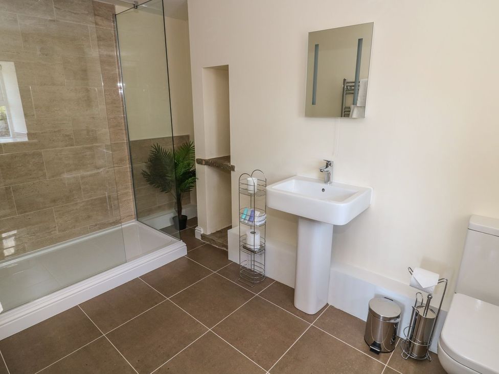 A bathroom with a shower and sink at Fogga Croft in Skipton
