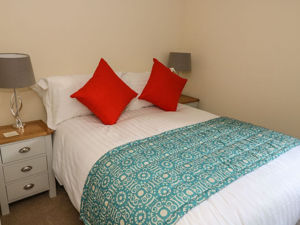 A bedroom with a bed and bedside table at Fogga Croft in Skipton