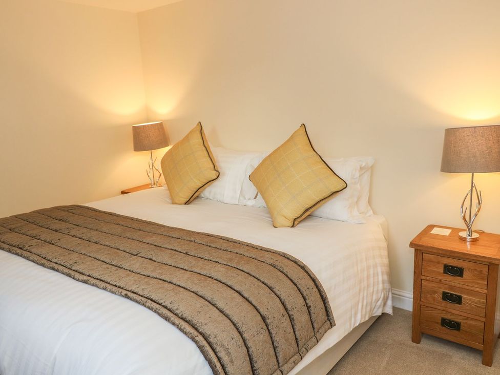 A bedroom with a bed and bedside table at Fogga Croft in Skipton