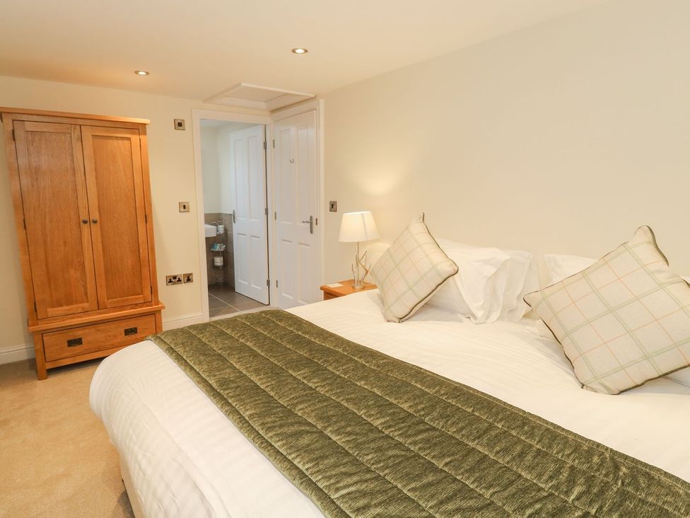 A bedroom with a bed and wardrobe at Fogga Croft in Skipton