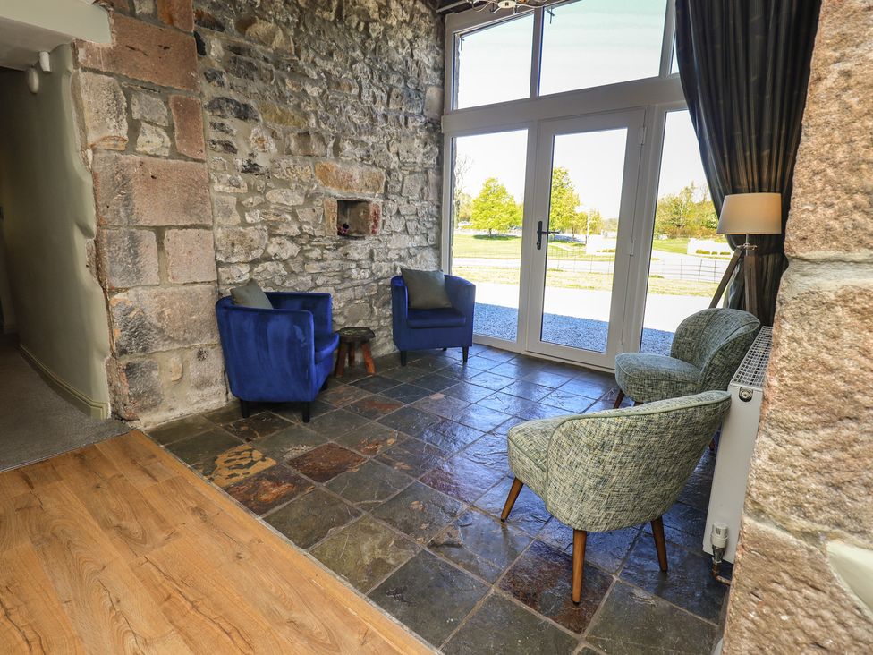 A snug with chairs and double doors at Fogga Croft in Gargrave