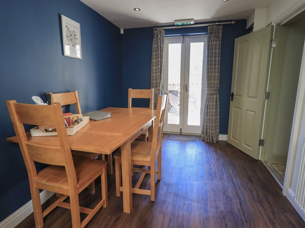 A dining room with a wooden table and chairs at Fogga Croft in Gargrave