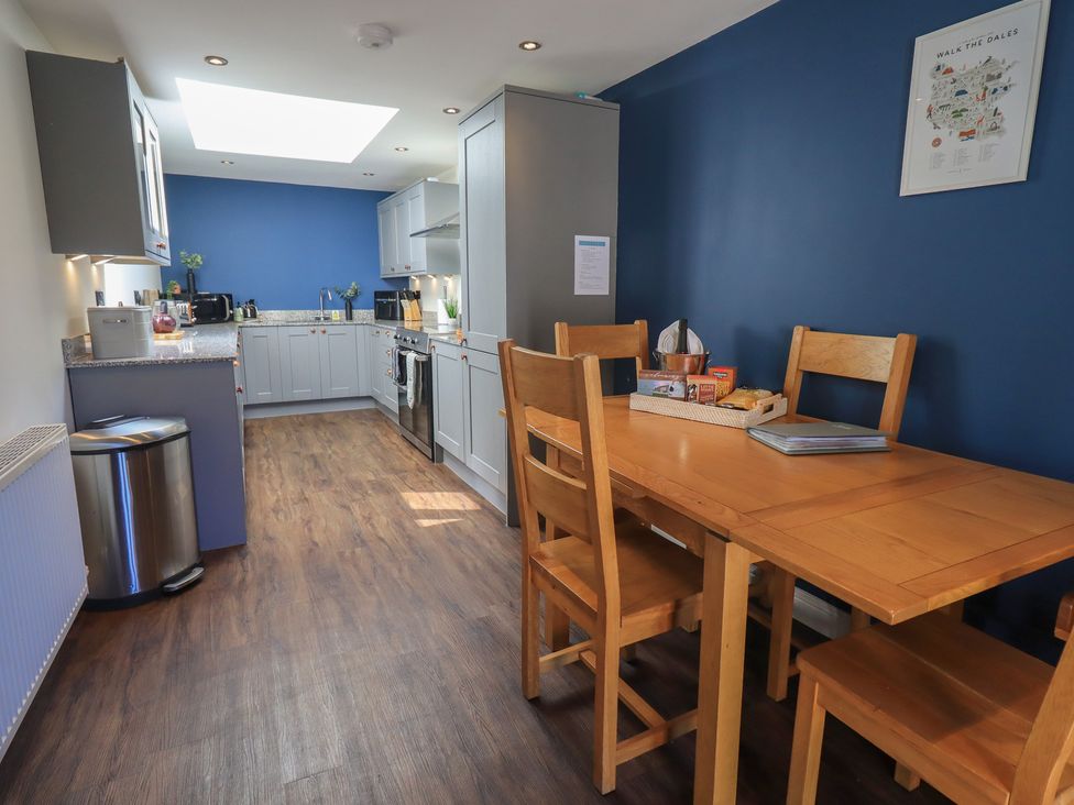 A kitchen with a dining table and appliances at Fogga Croft in Gargrave