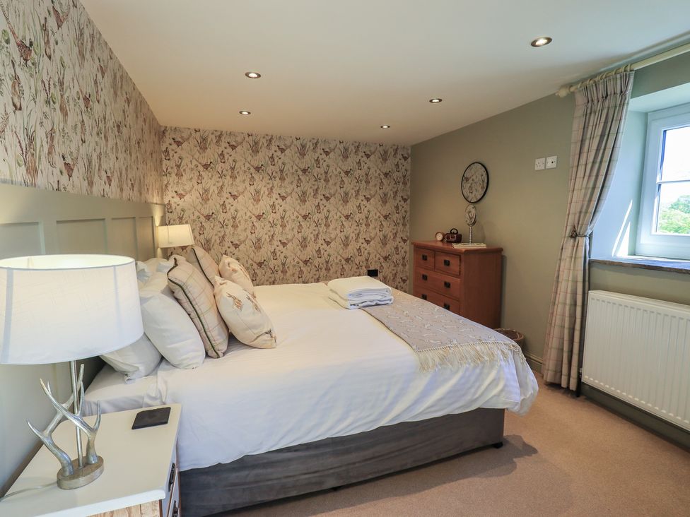 A bedroom with a bed and dresser at Fogga Croft Gargrave