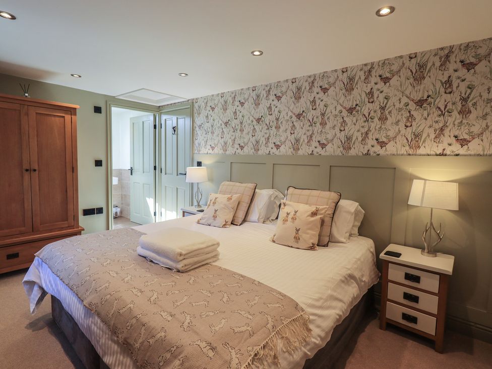 A bedroom with a bed and wardrobe at Fogga Croft Gargrave