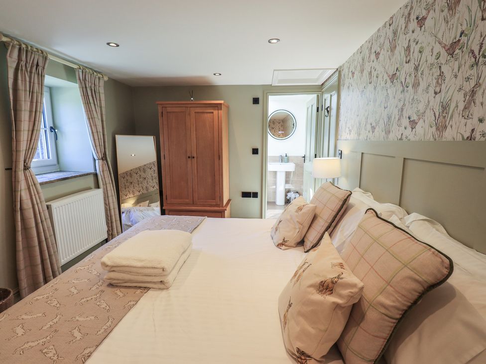 A bedroom with a bed and wardrobe at Fogga Croft in Gargrave