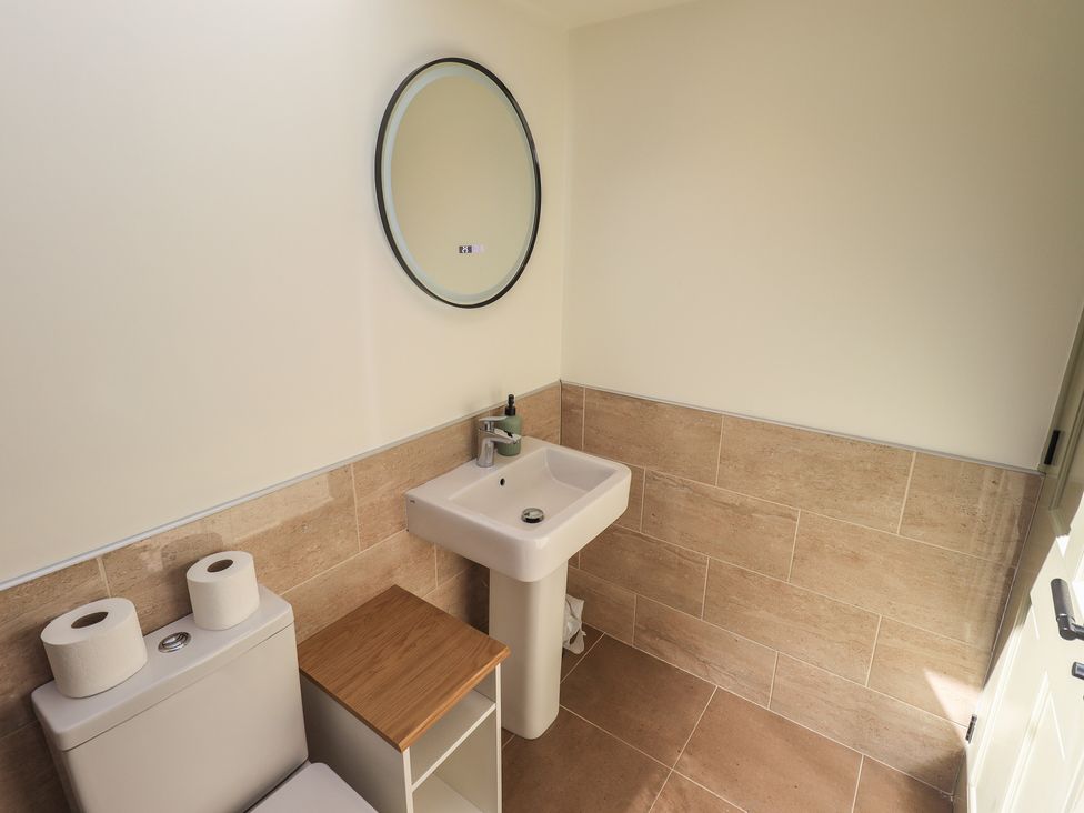 A bathroom with a toilet and sink at Fogga Croft in Gargrave
