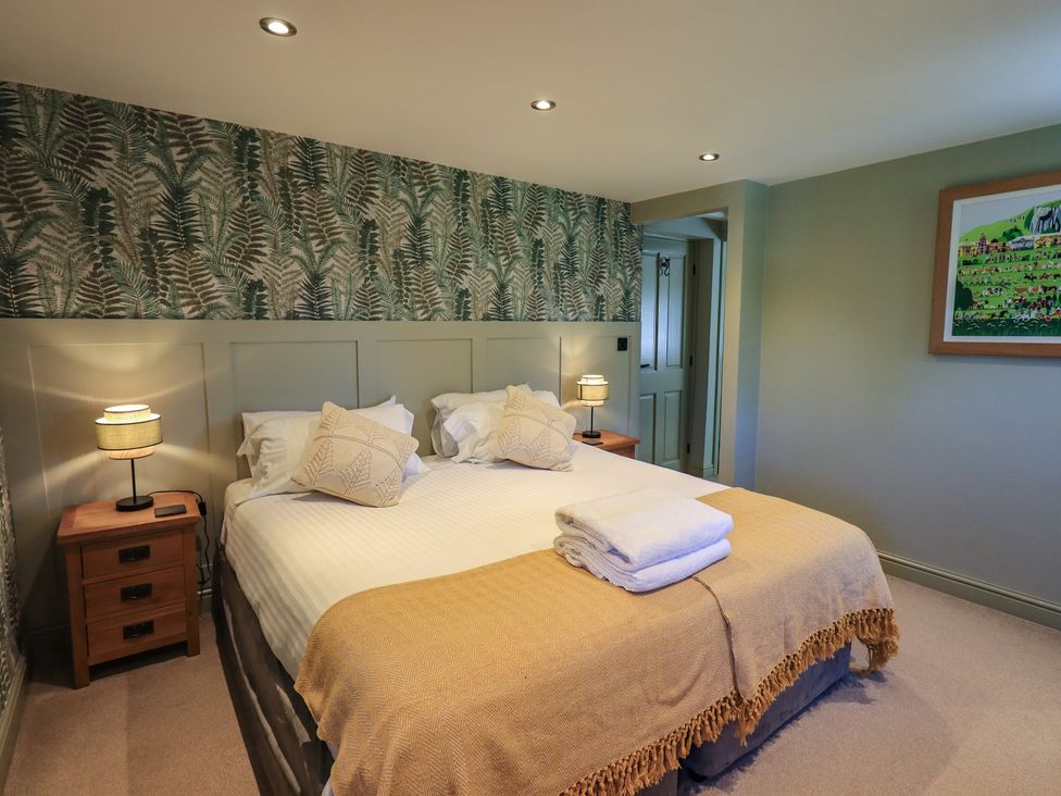 A bedroom with a double bed and bedside table at Fogga Croft in Gargrave