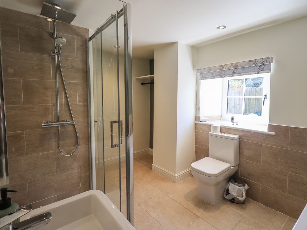 A bathroom with a shower, toilet, and sink at Fogga Croft in Gargrave