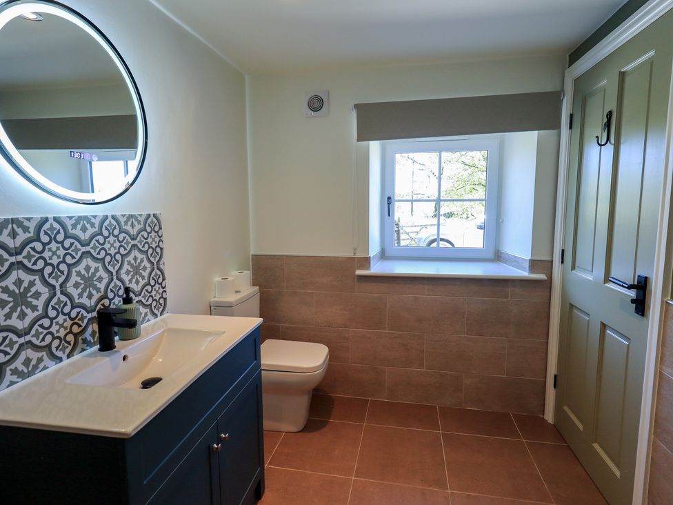 A bathroom with a wash basin and a window at Fogga Croft in Gargrave