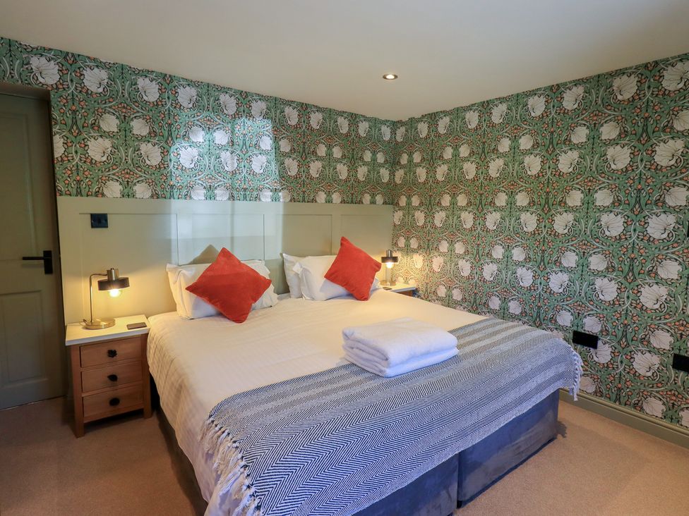 A bedroom with a bed and bedside table at Fogga Croft in Gargrave