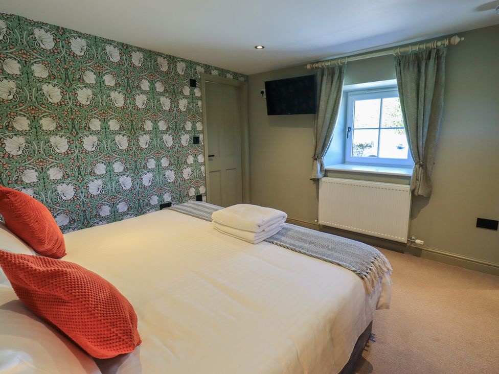 A bedroom with a bed and television at Fogga Croft in Gargrave