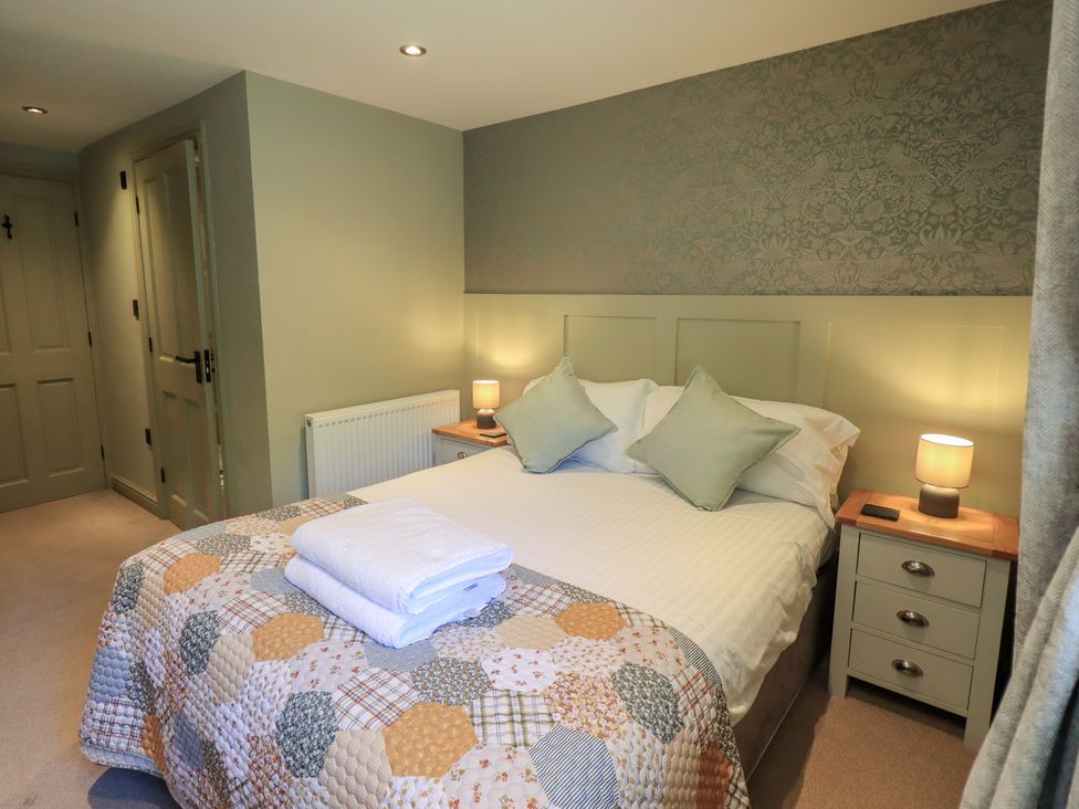 A bedroom with a bed and bedside table at Fogga Croft in Gargrave