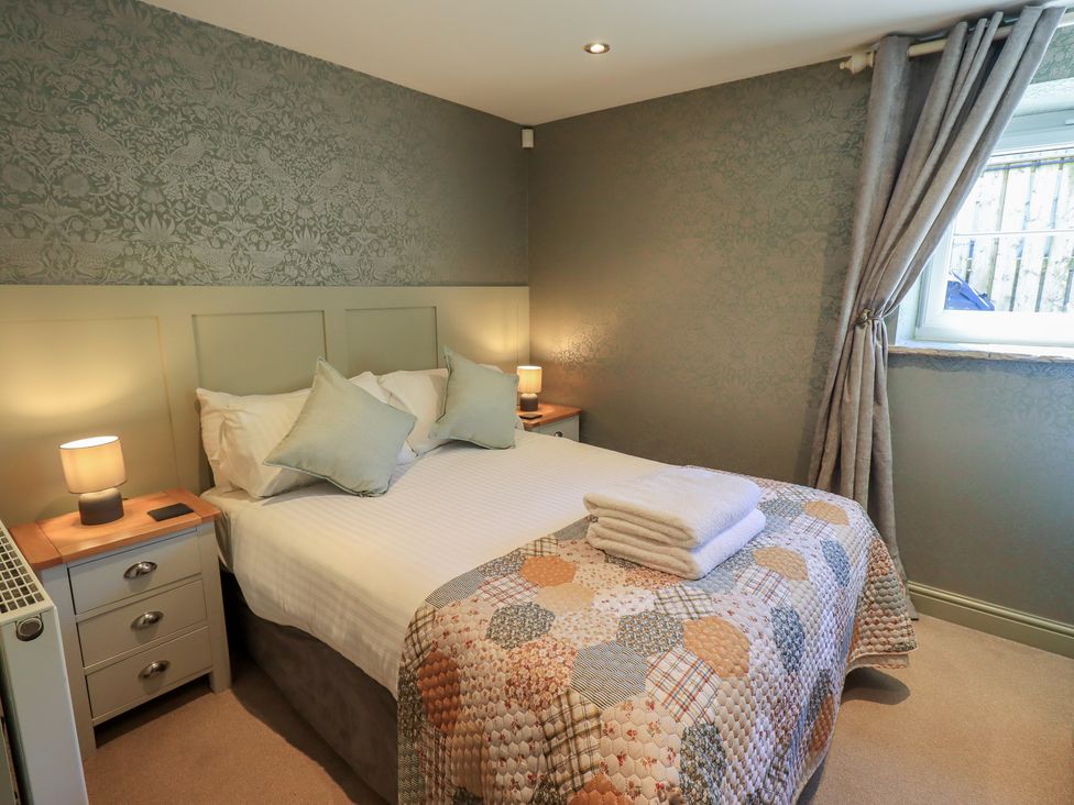 A bedroom with a bed and bedside tables at Fogga Croft in Gargrave