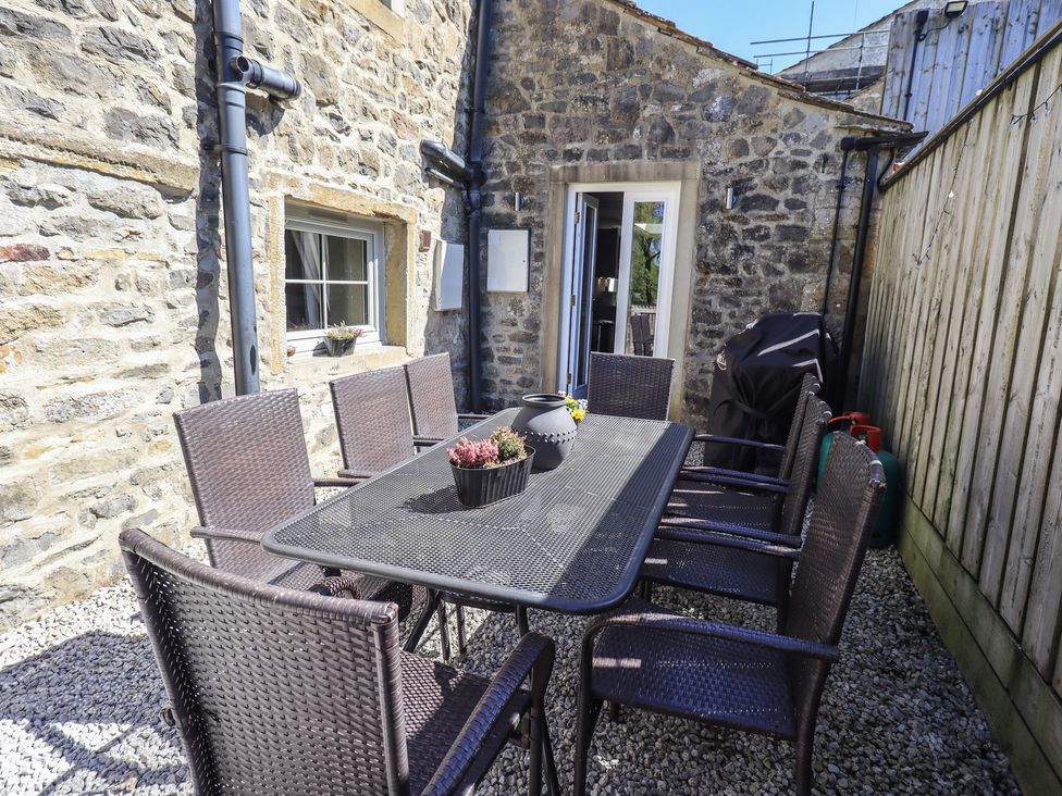 An outdoor patio with a table and chairs at Fogga Croft in Gargrave