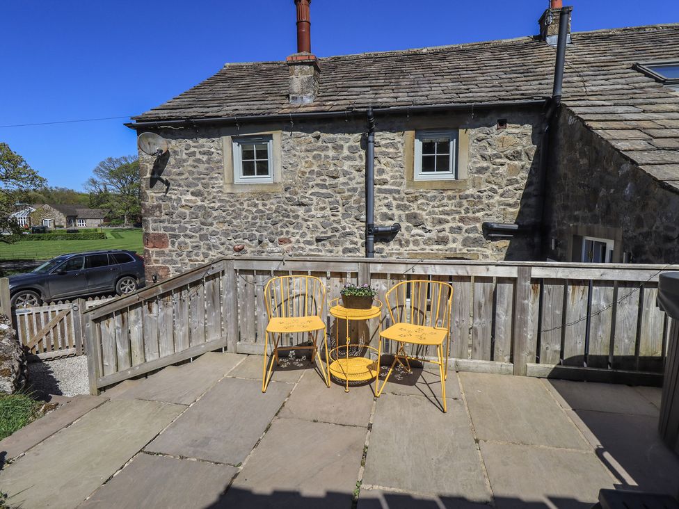 An outdoor area with yellow chairs and a table at Fogga Croft in Gargrave