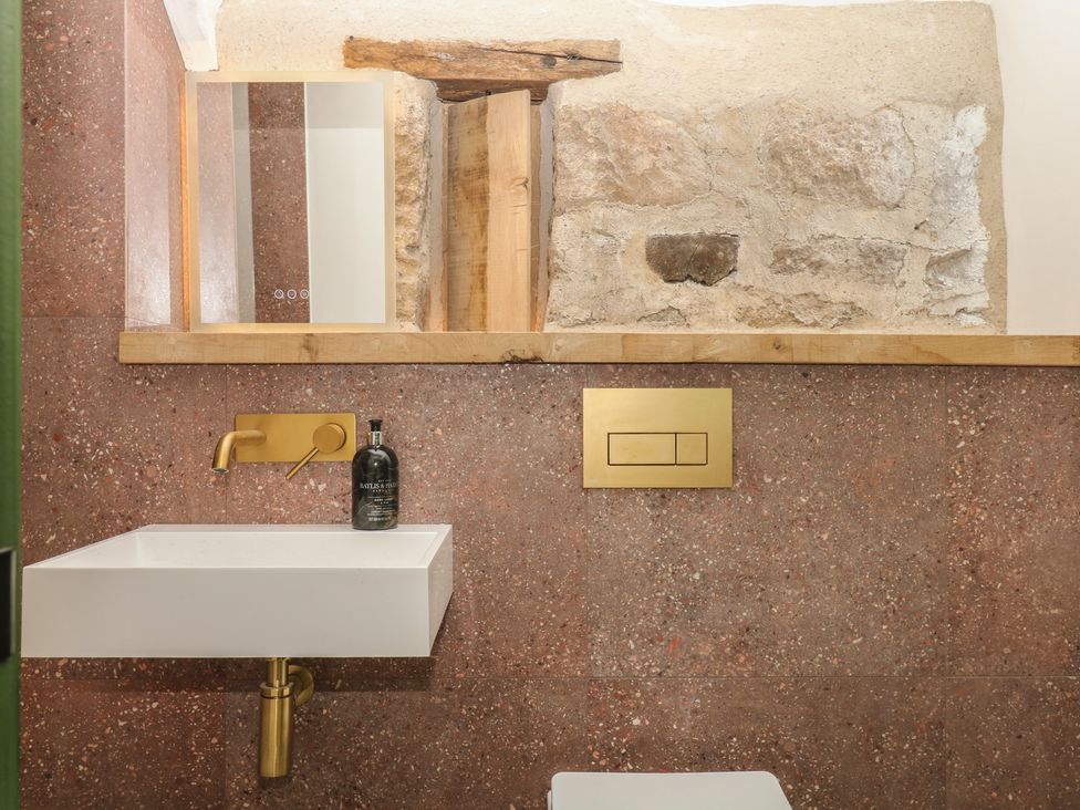 A bathroom with a sink and mirror at Reddaway Threshing Barn near Okehampton