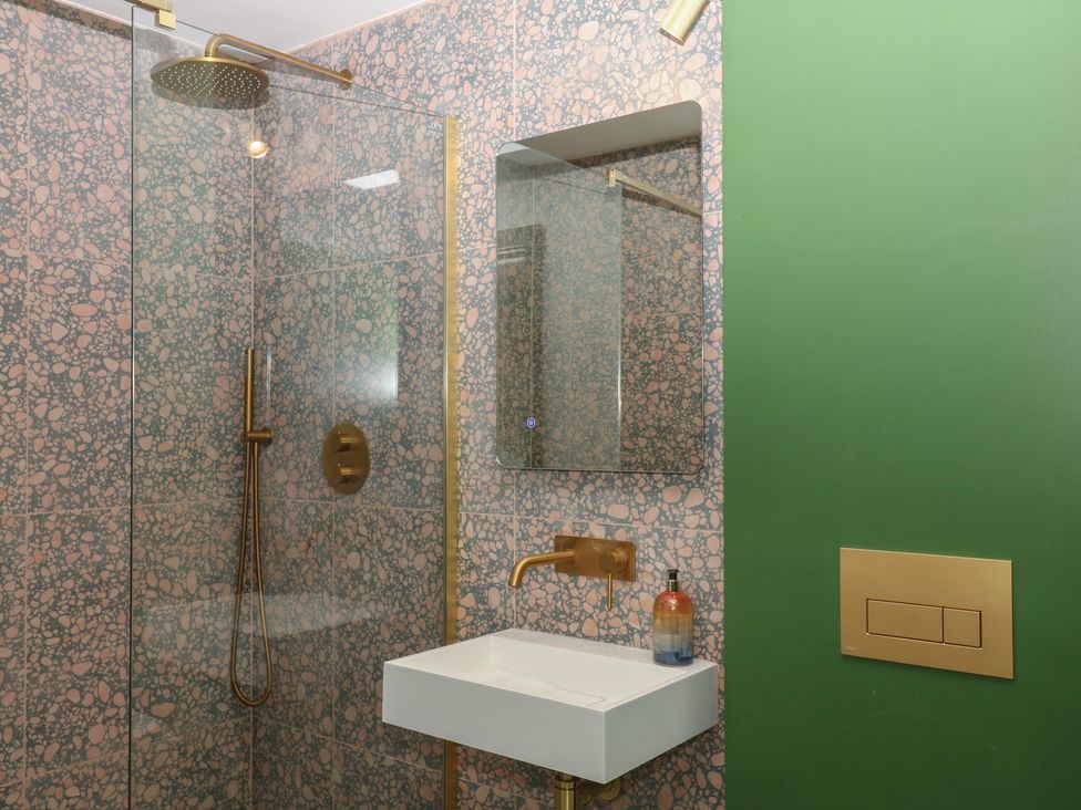 A bathroom with shower and sink at Reddaway Threshing Barn near Okehampton