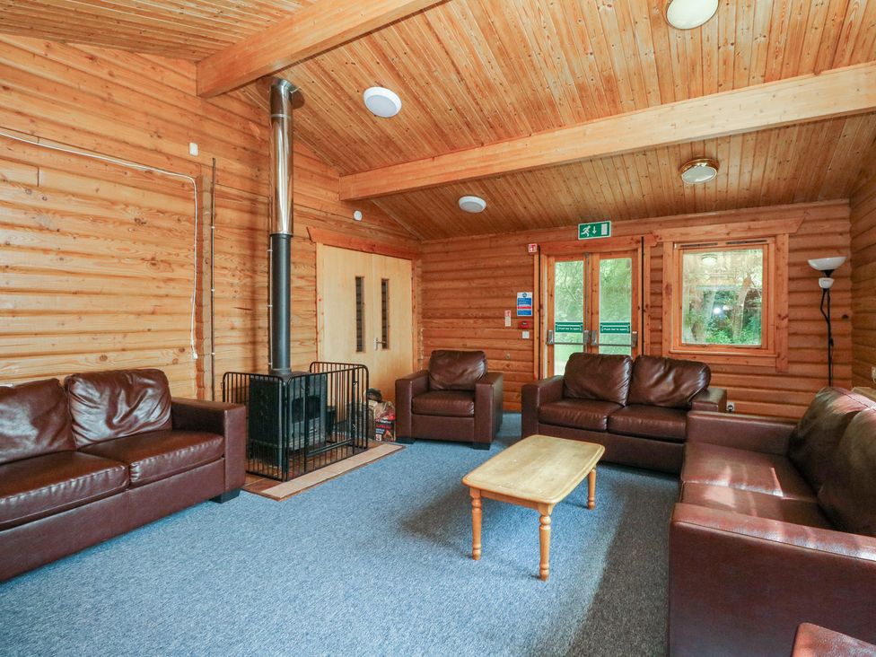 A living room with sofas and a fireplace at Shore Lodge in Brodick