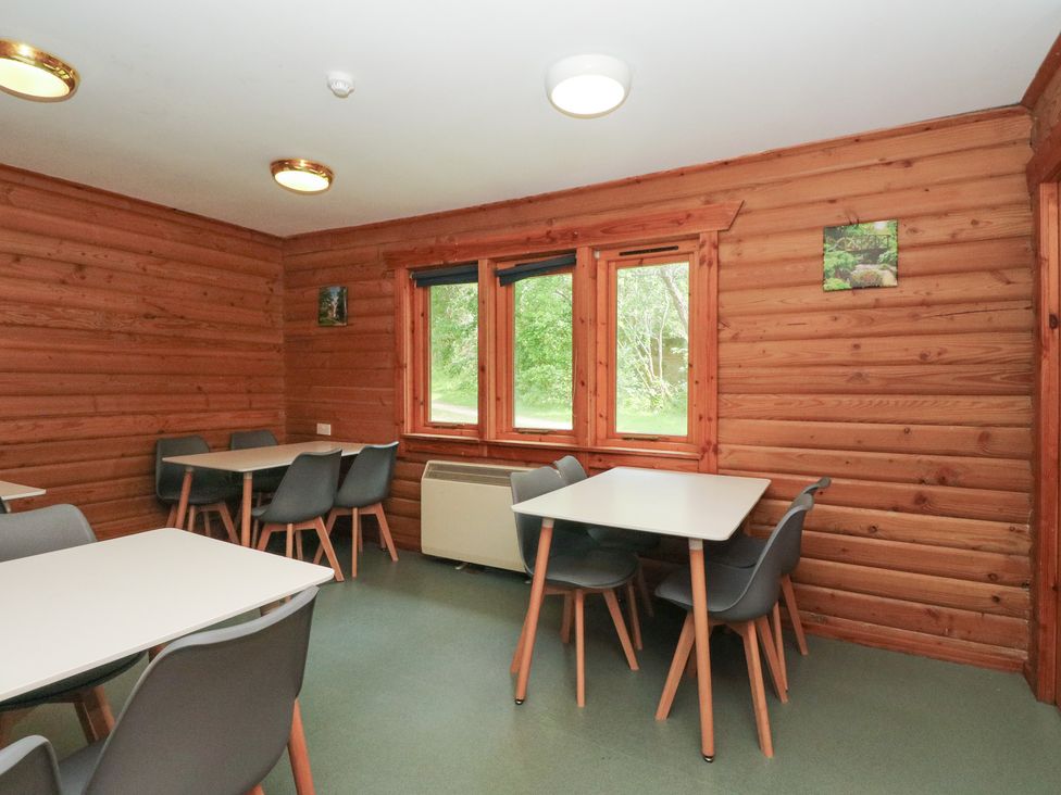 A dining room with tables and chairs at Shore Lodge Brodick