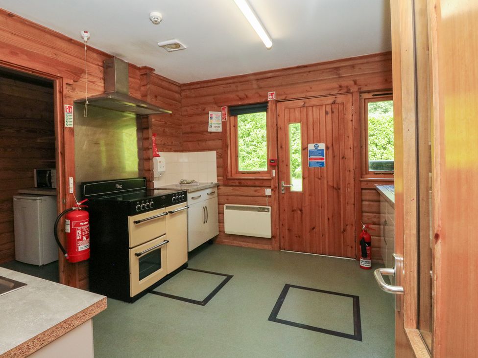 A kitchen with an oven and sink at Shore Lodge in Brodick