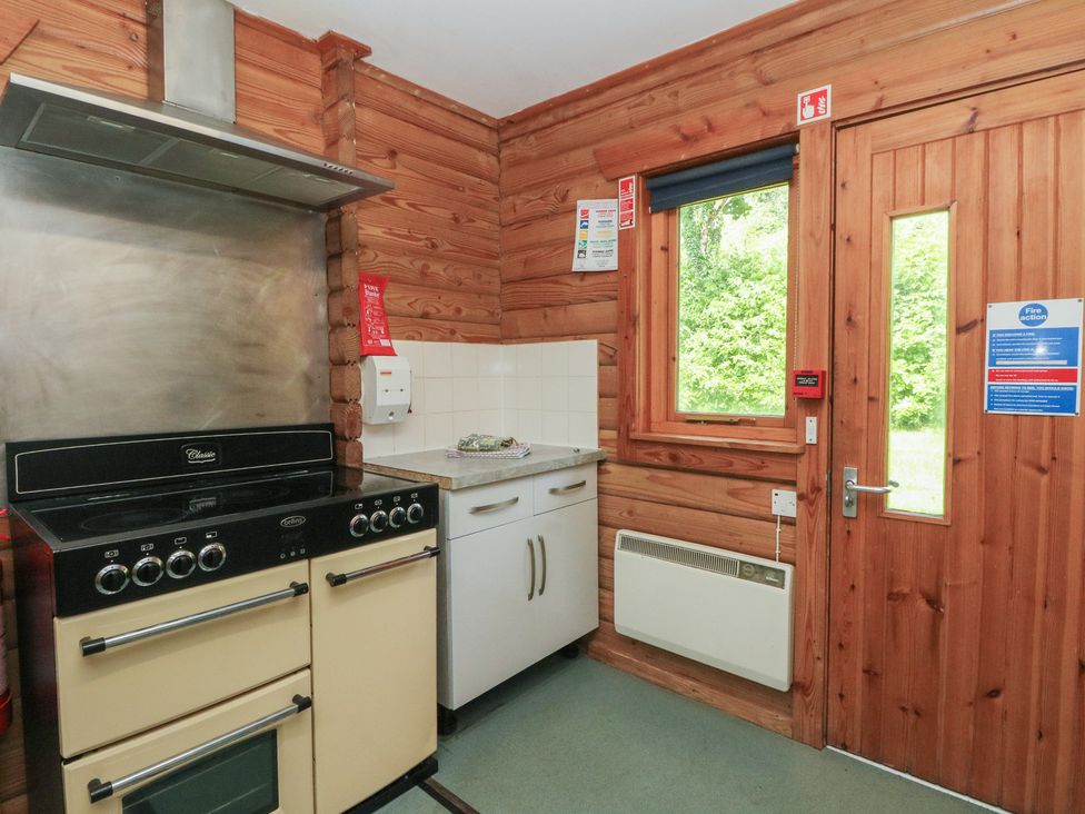 A kitchen with an oven and window at Shore Lodge in Brodick