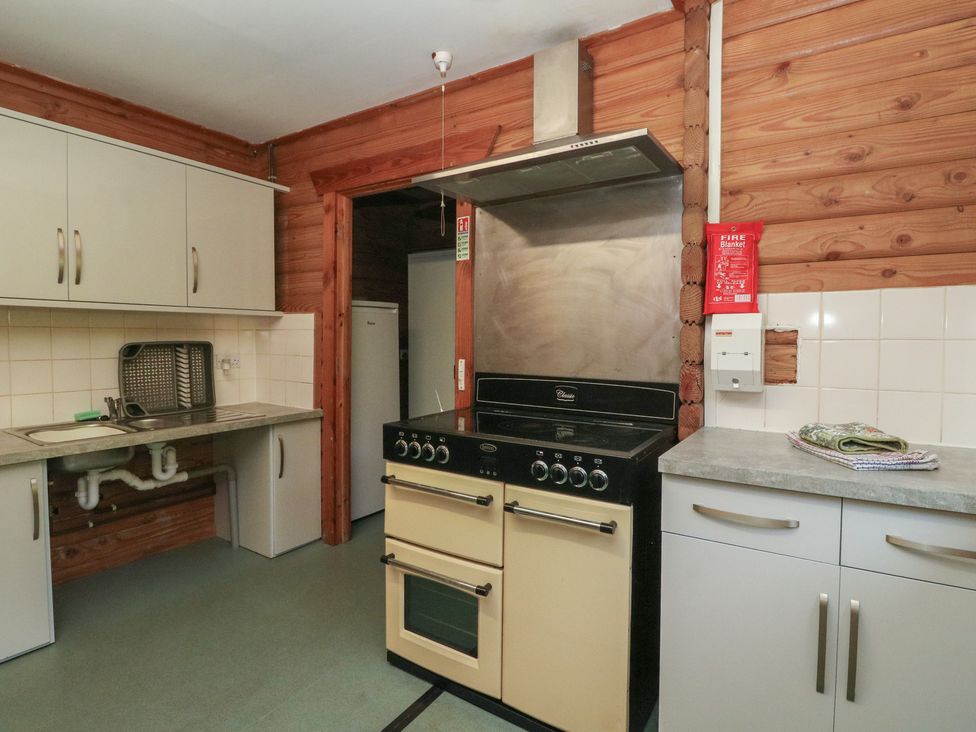 A kitchen with a stove and sink at Shore Lodge in Brodick