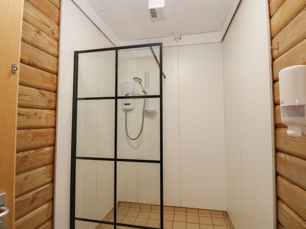 A bathroom with a shower enclosure at Shore Lodge in Brodick