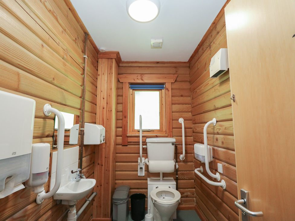 A bathroom with a toilet and sink at Shore Lodge in Brodick