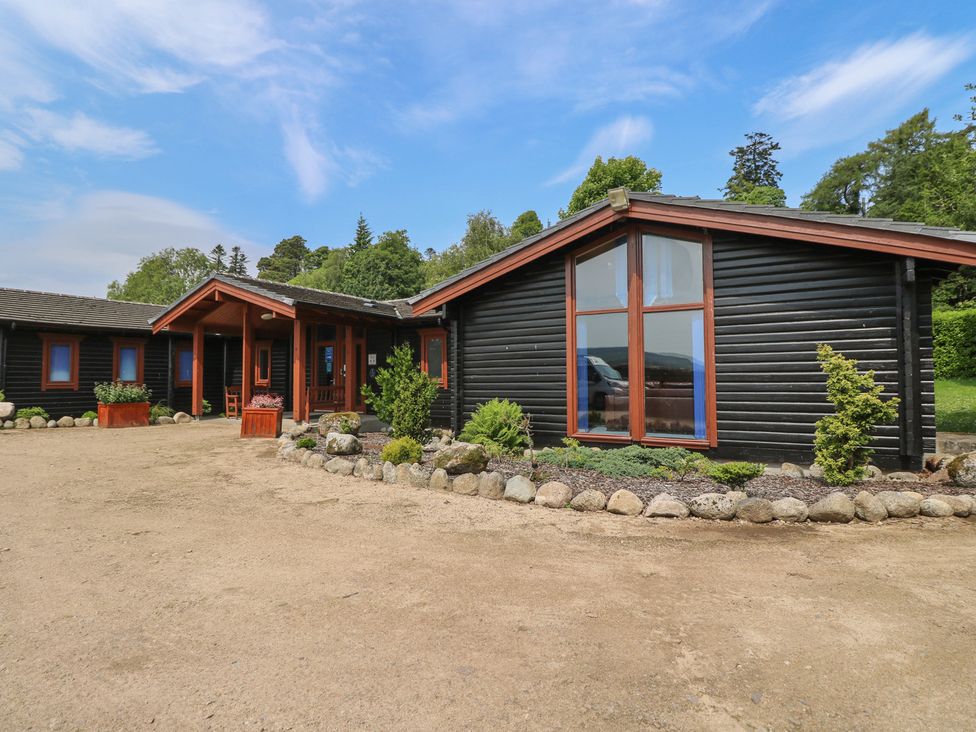An outdoor view of a house with plants and a pathway at Shore Lodge in Brodick
