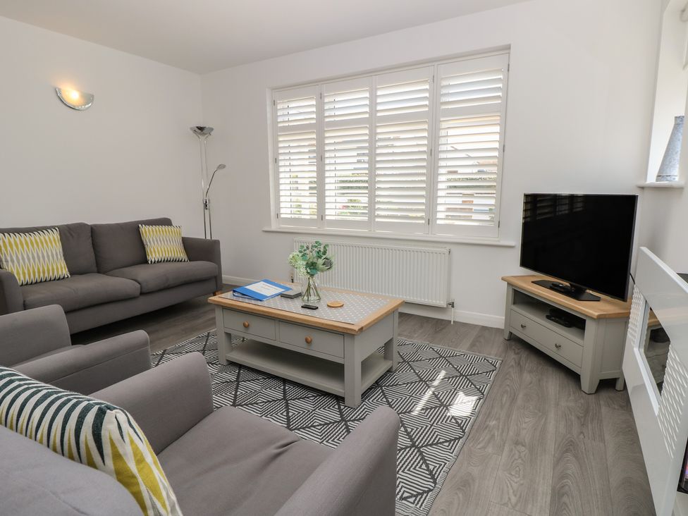 A living room with a sofa and television at 50 Sea Road Milford On Sea