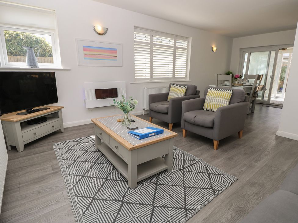 A living room with a television and coffee table at 50 Sea Road Milford On Sea